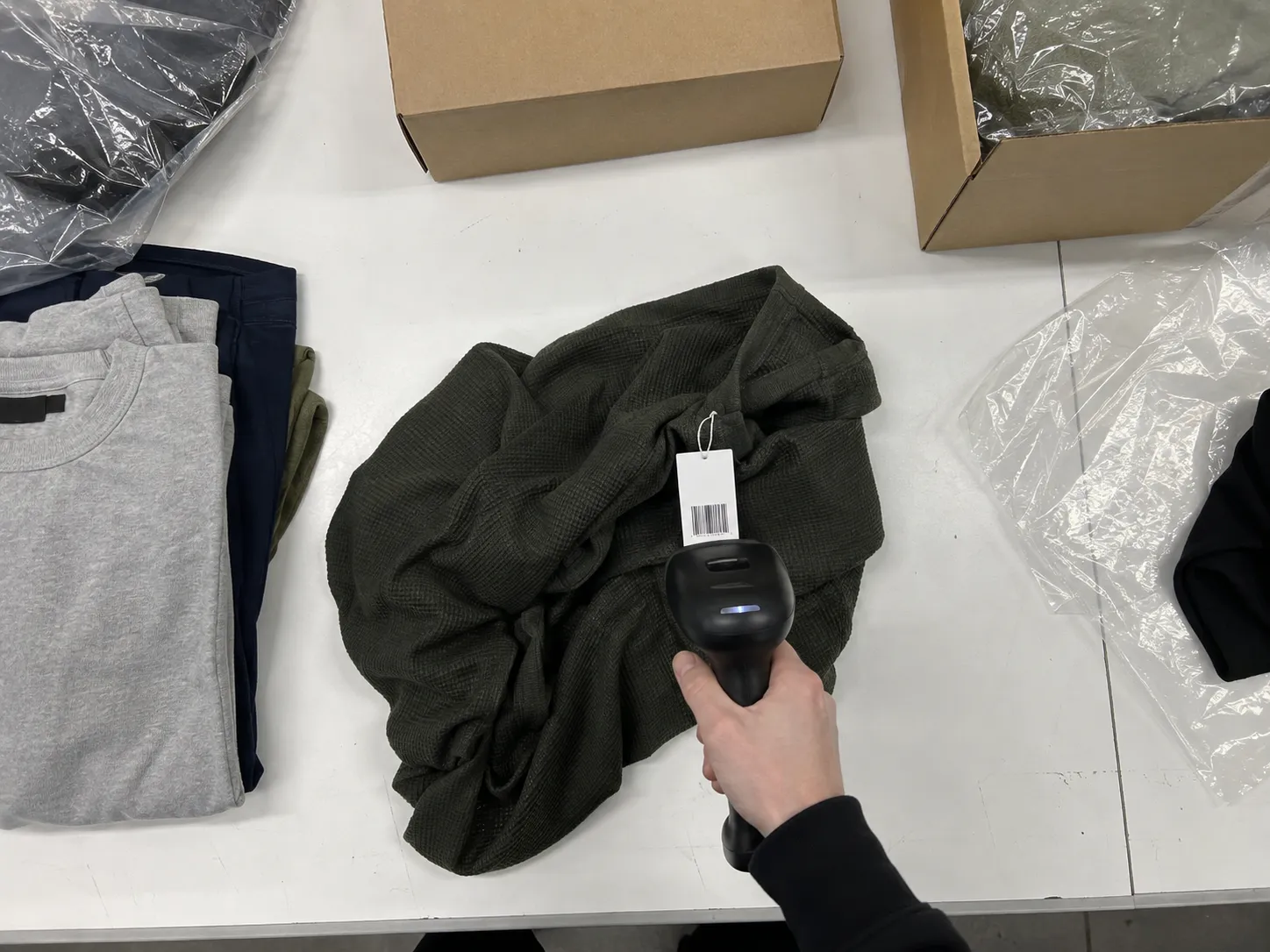 Overhead view of a barcode scanner reading a garment tag